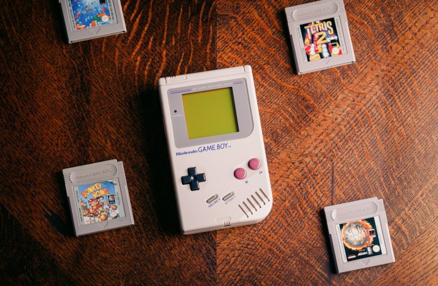 a nintendo game boy sitting on top of a wooden table