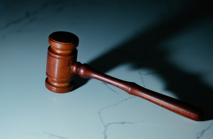 a wooden judge's hammer sitting on top of a table