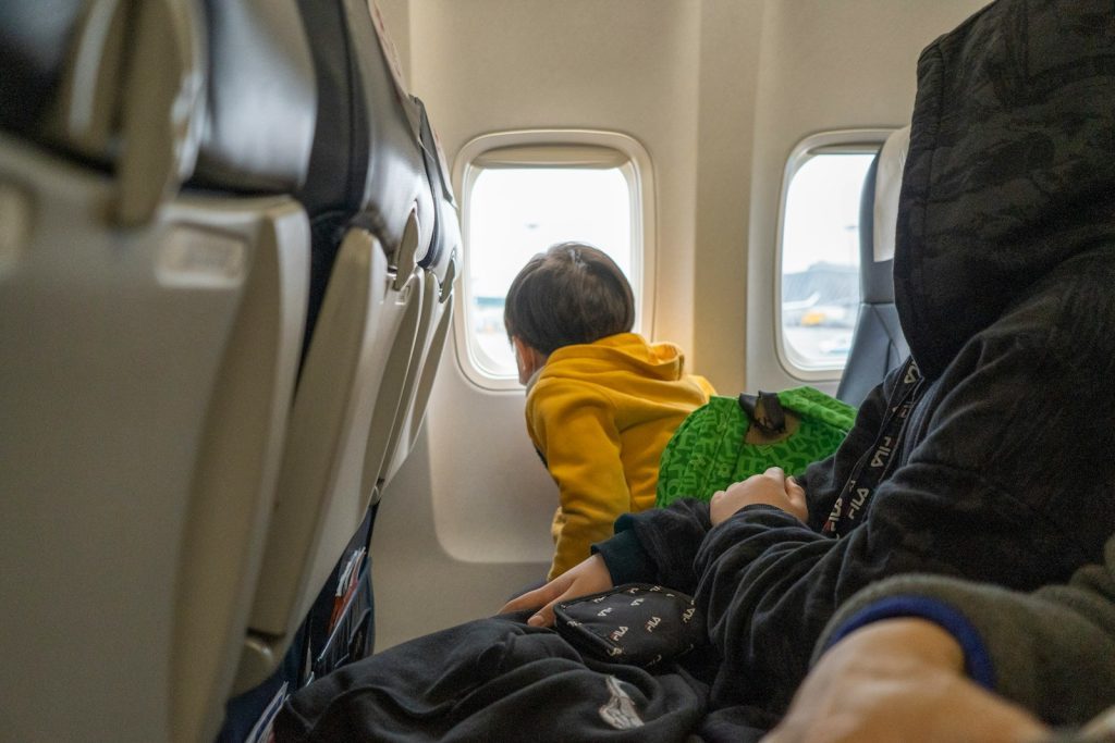 a small child sitting on a seat in an airplane