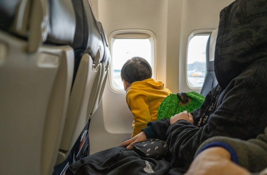 a small child sitting on a seat in an airplane