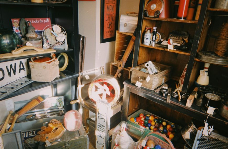 Collection of vintage items on shelves and floor.