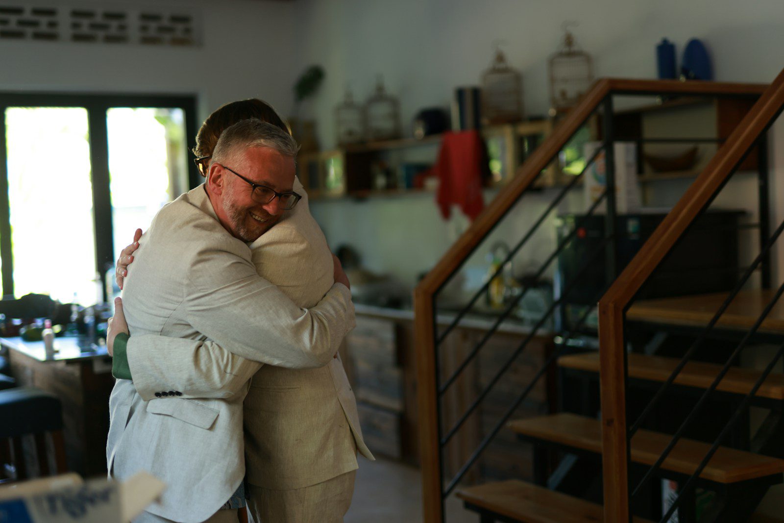 Two men hugging each other indoors