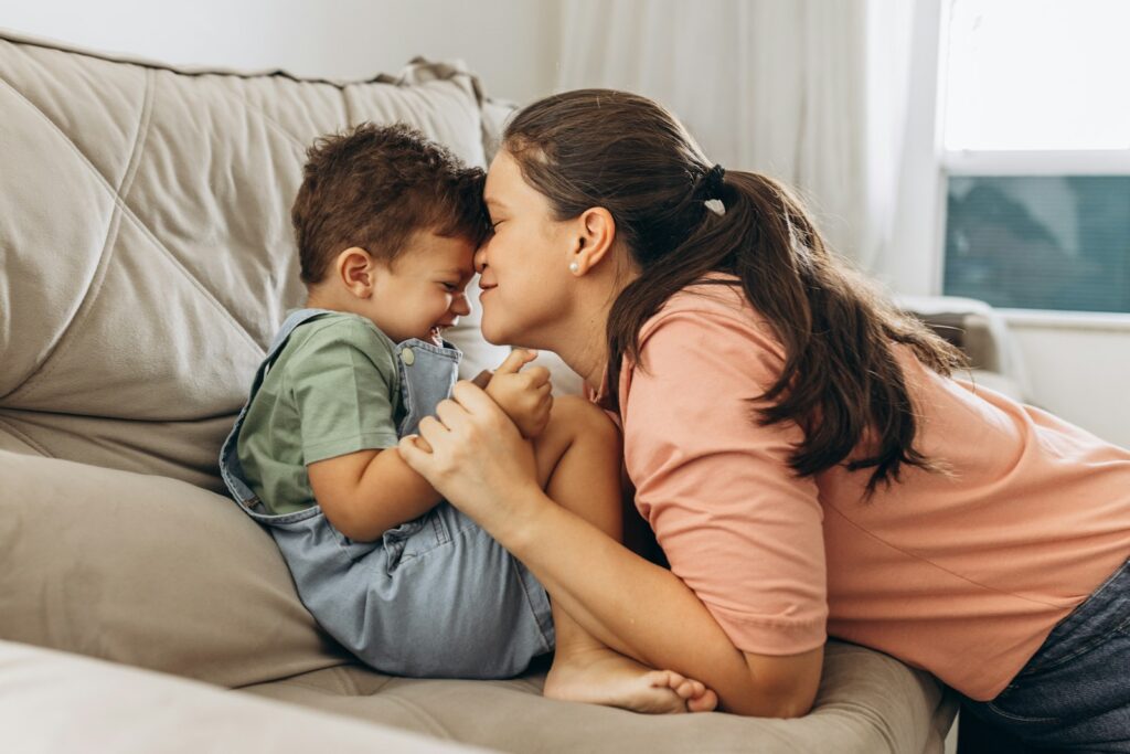 a woman holding a small child on a couch