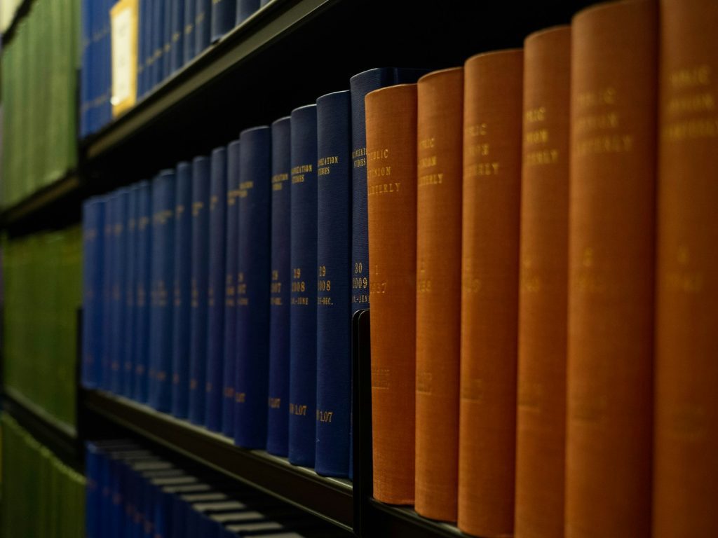 a row of books on a shelf in a library