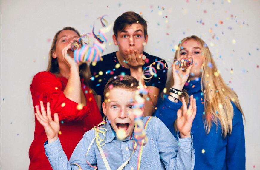 people blowing party favors