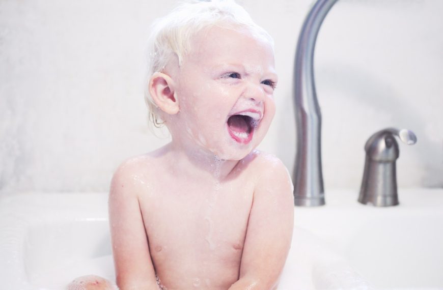 portrait photography of baby laughing