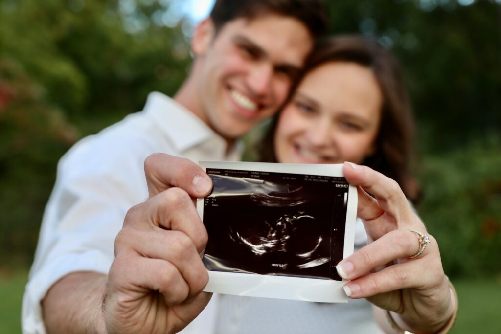 a man and woman looking at a cell phone