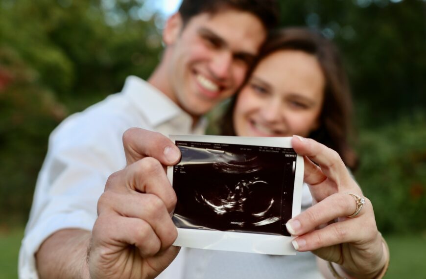 a man and woman looking at a cell phone