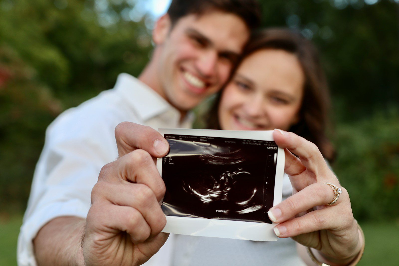 a man and woman looking at a cell phone