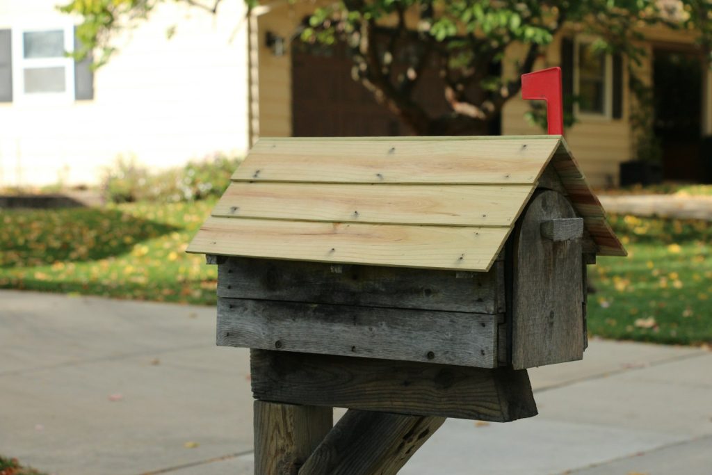 Wooden mailbox with a new roof