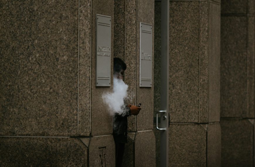 man in black jacket smoking