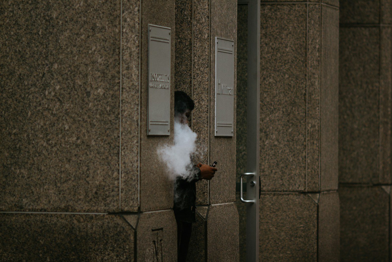 man in black jacket smoking