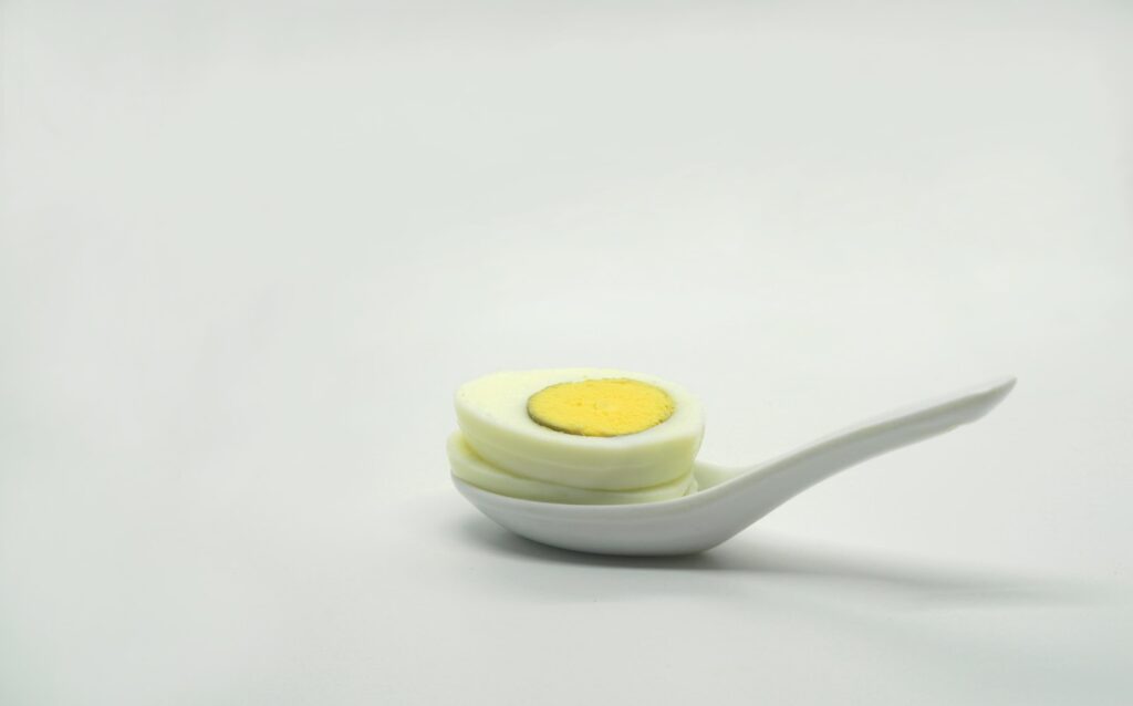 a white spoon with a yellow substance on it