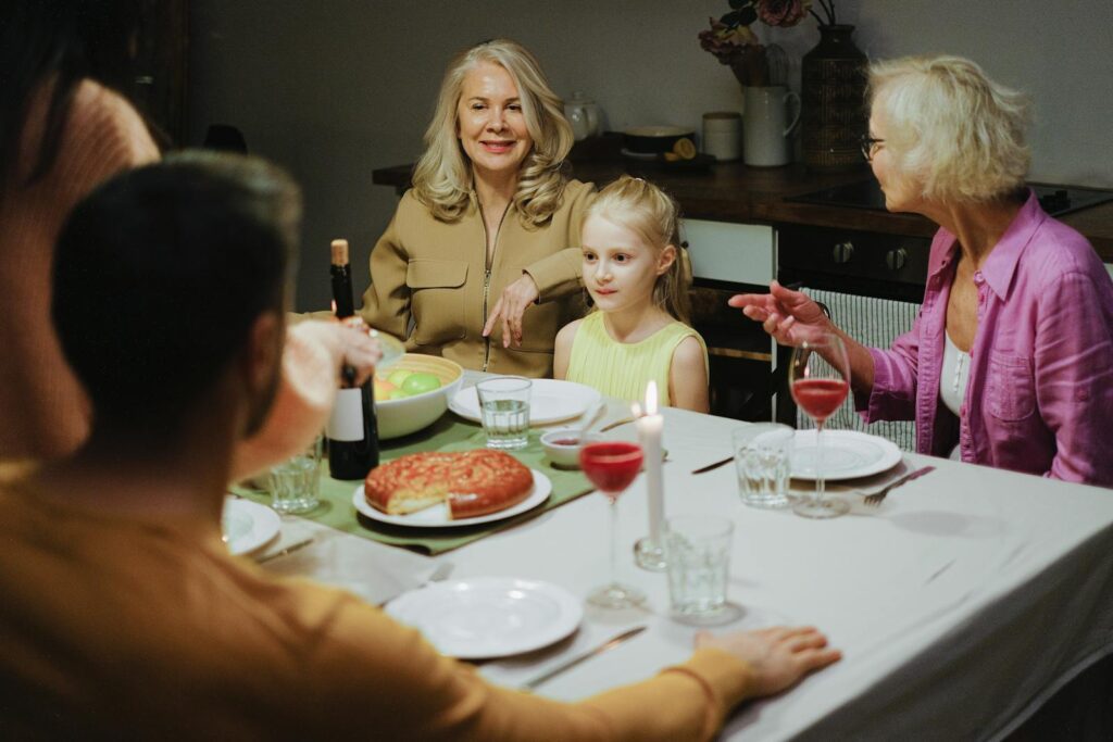 A multigenerational family enjoying dinner together at home, highlighting family bonds and togetherness.