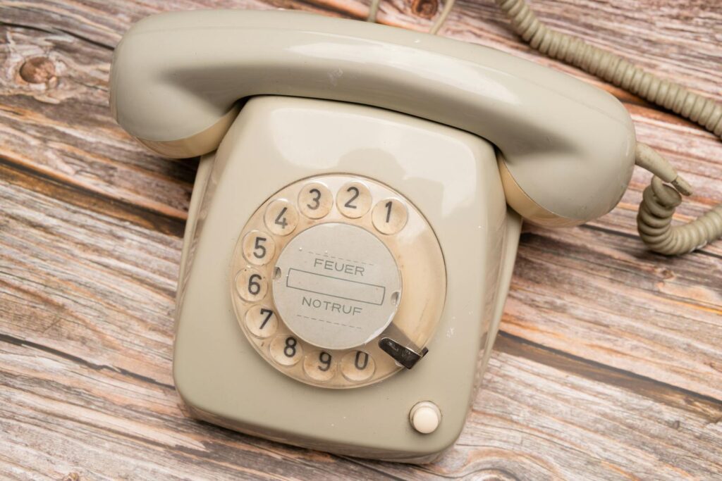 Classic retro rotary phone on a wooden surface, evoking nostalgia and communication history.