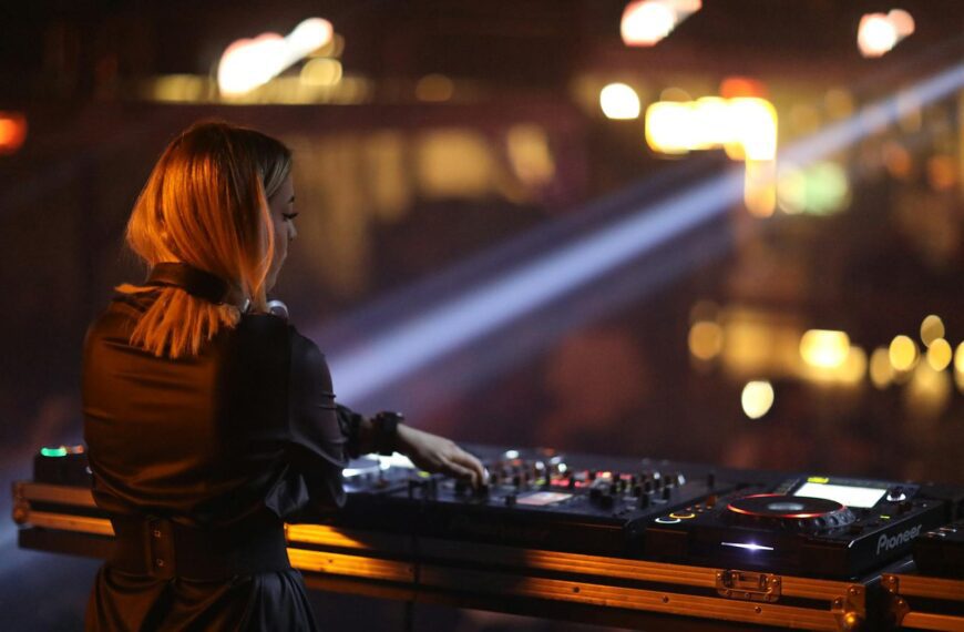 A young female DJ skillfully mixing tracks in a lively nightclub scene, showcasing music and nightlife vibes.