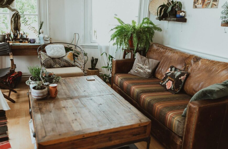 A cozy living room featuring rustic furniture and lush greenery for a relaxed ambiance.