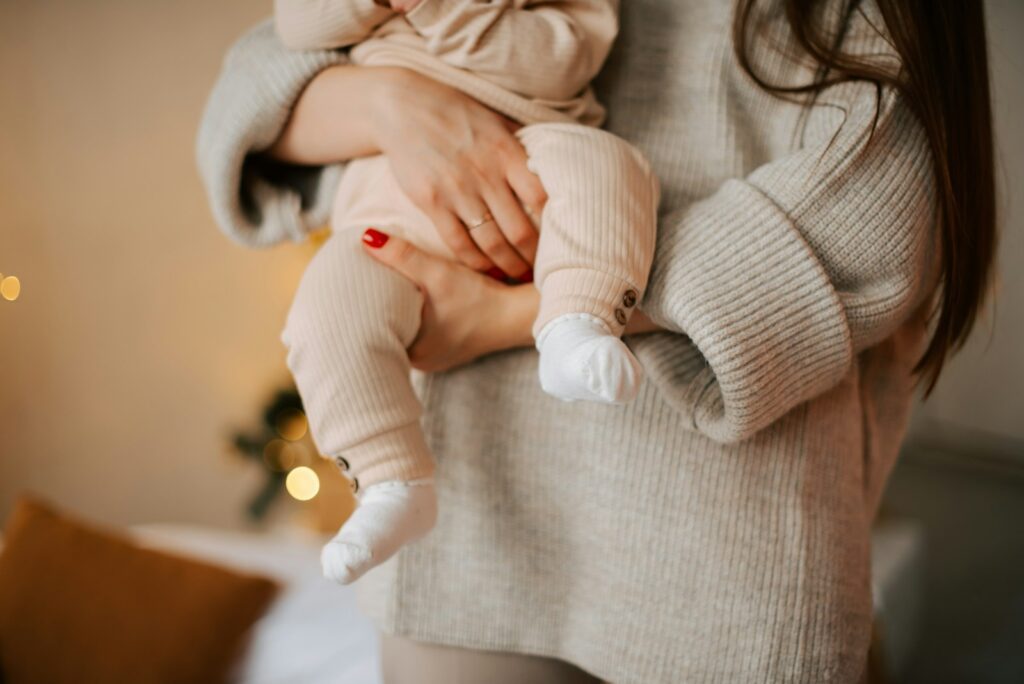 a woman holding a baby in her arms