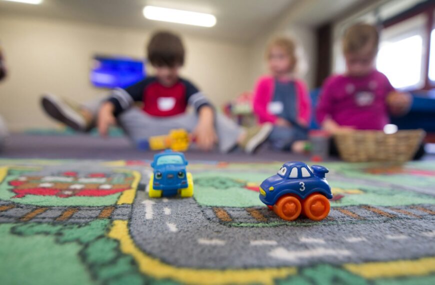 a group of children playing with toys on the floor