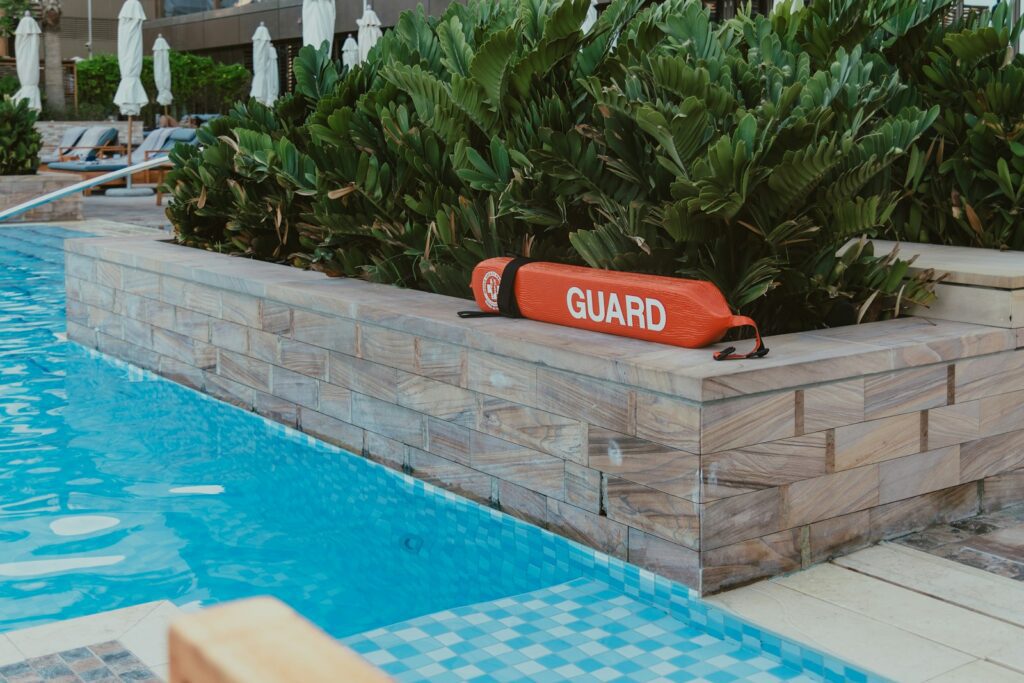 A pool with a guard sign in the middle of it