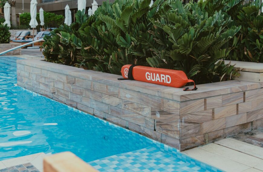 A pool with a guard sign in the middle of it
