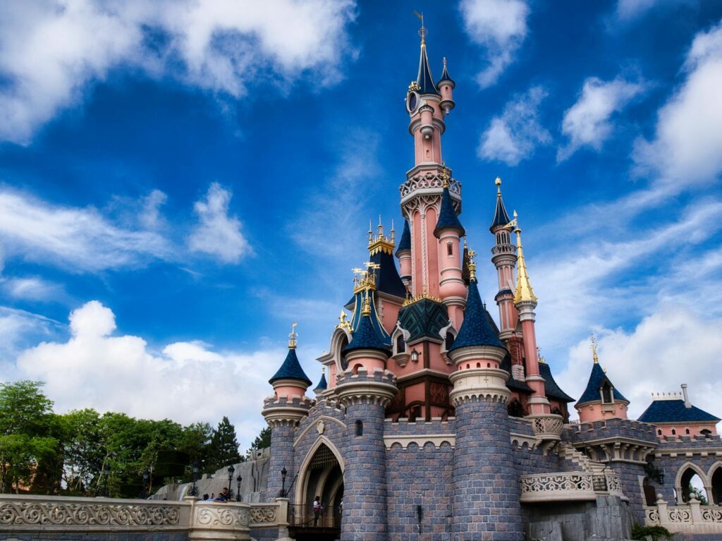 Magical view of the iconic Disneyland Paris castle with a vibrant blue sky.