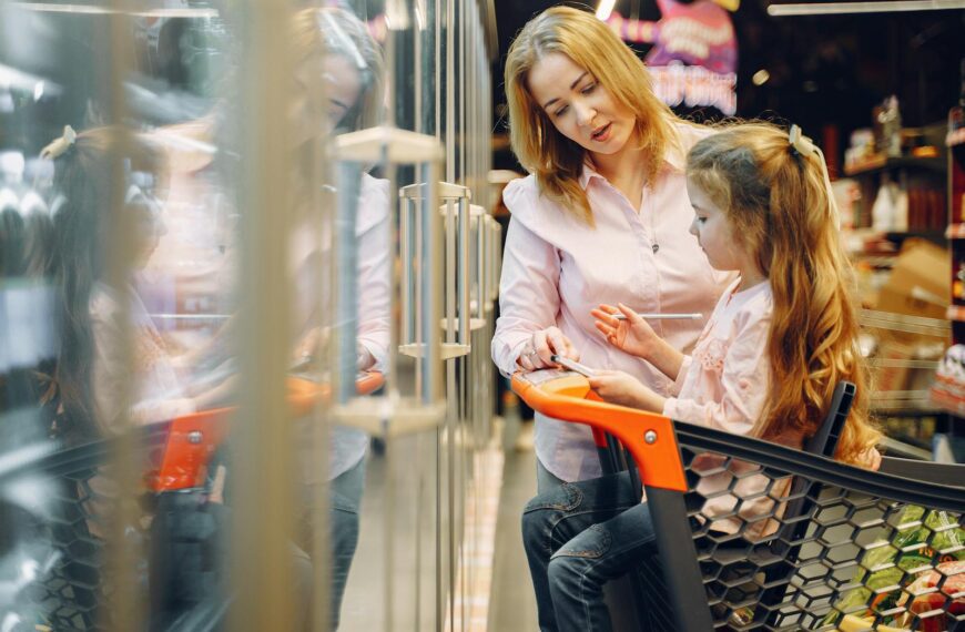 A mother and daughter bonding while shopping at the supermarket together.