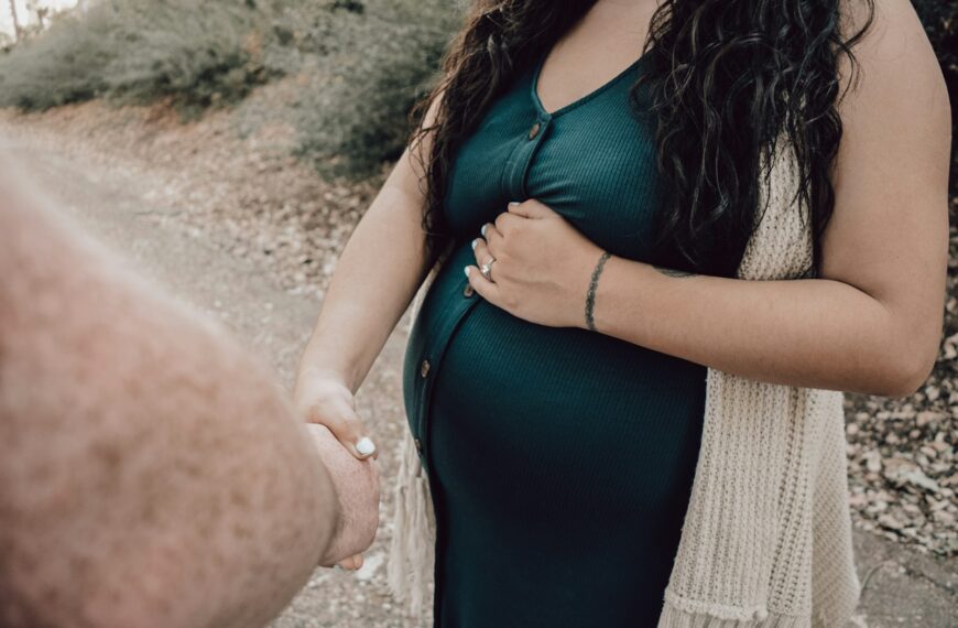 woman in black tank top and white knit cardigan