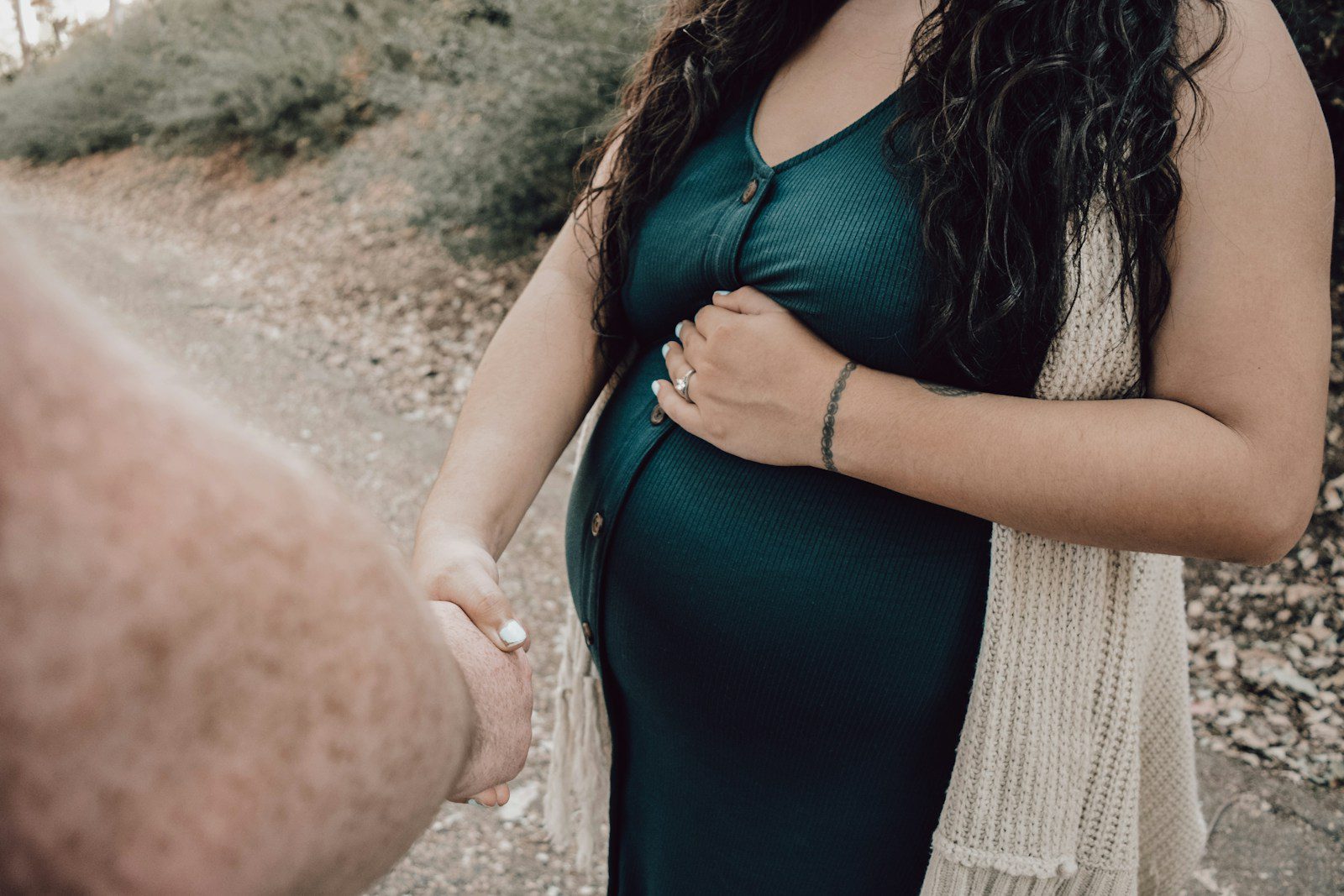 woman in black tank top and white knit cardigan