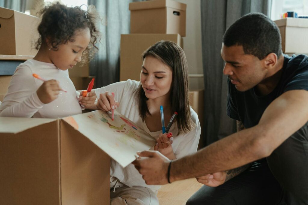 Family enjoying a creative moment while moving into a new home.
