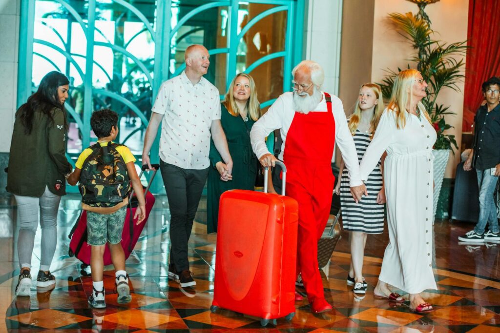 A diverse family happily arrives at a stylish Dubai hotel with bright luggage and smiles all around.