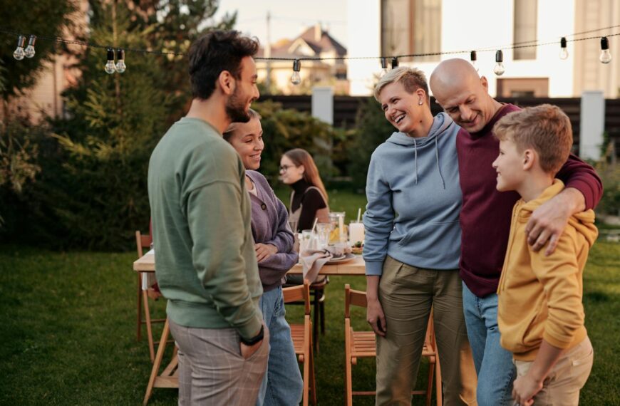 A joyful family gathering outside on a sunny day, sharing laughter and companionship.