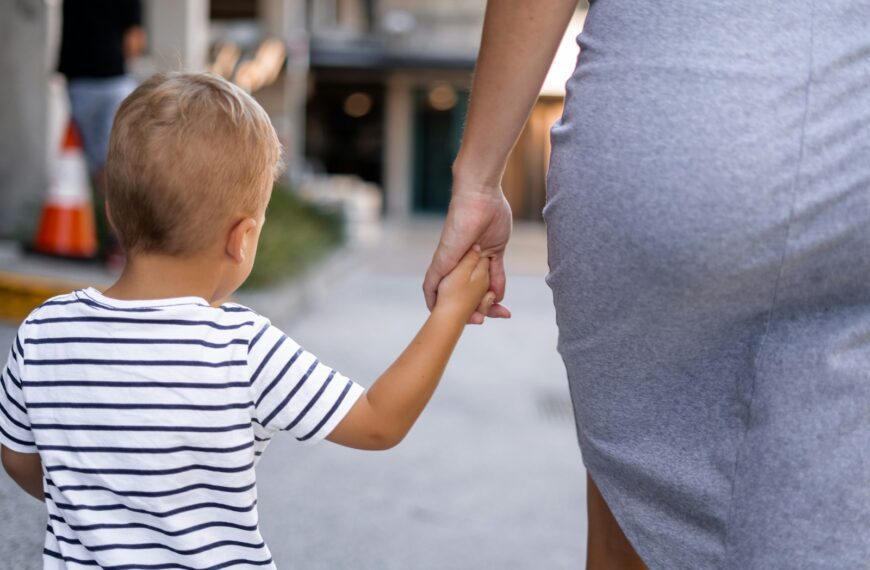 boy and woman holding hands outdoor