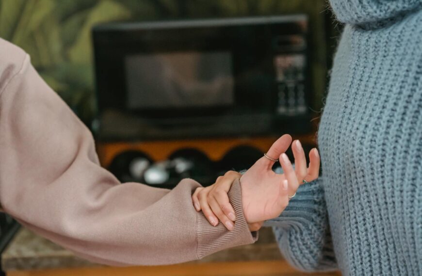 A close-up shot of two women involved in a tense interaction, showcasing emotions through body language.