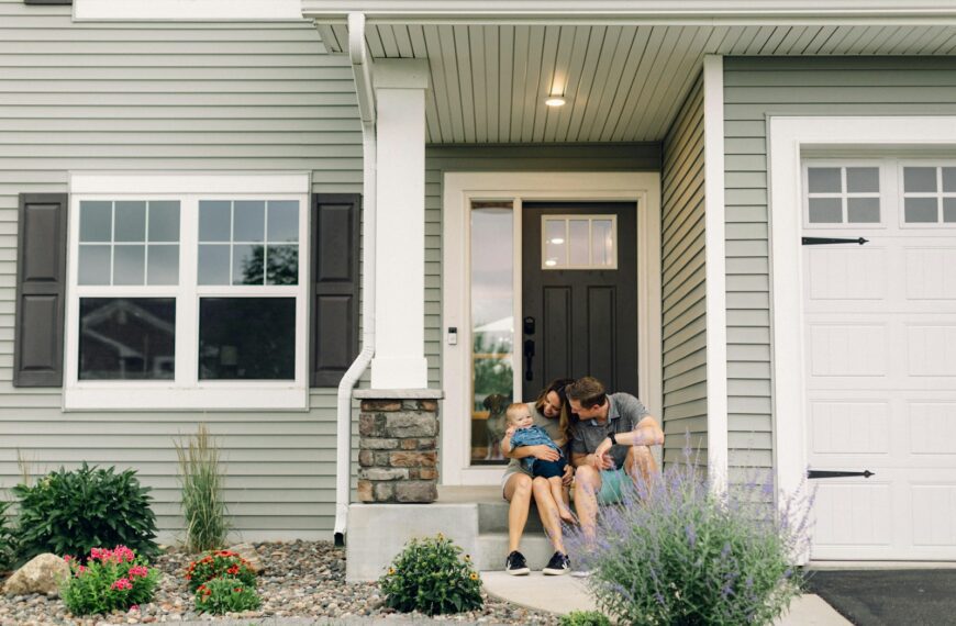 a couple of people that are sitting in front of a house