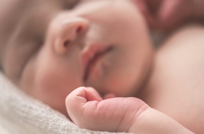 sleeping baby on white textile
