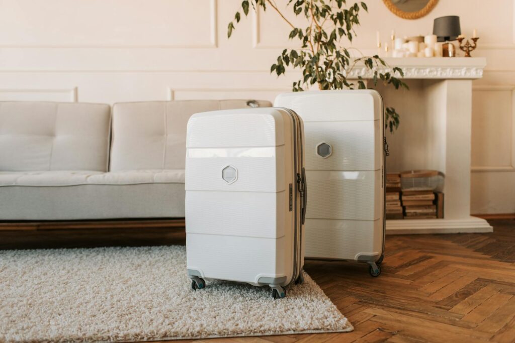 Stylish white suitcases displayed in a cozy living room setting.