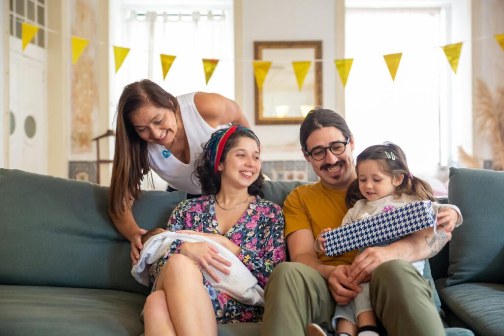 A joyful family gathering in a living room in Portugal, celebrating with smiles and togetherness.