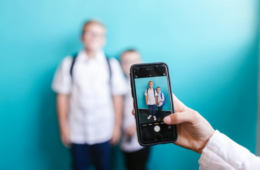 A close-up shot of a smartphone capturing two boys against a vibrant background.