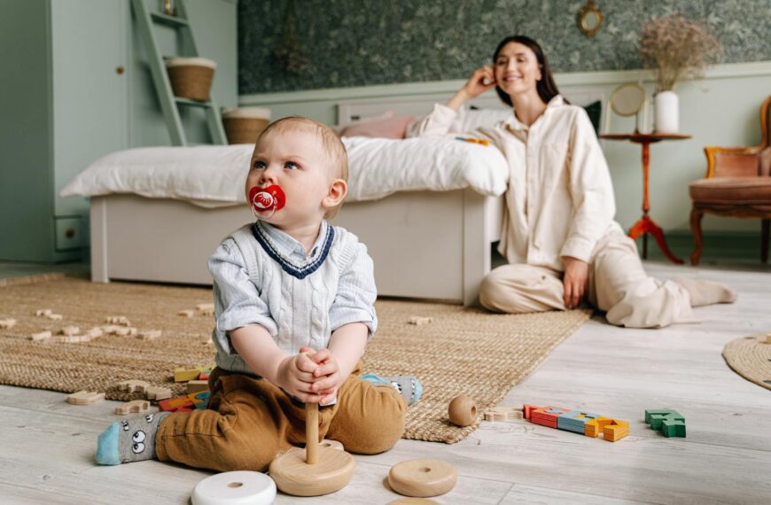 Mom and son enjoying playtime indoors with wooden toys, capturing the essence of family bonding.