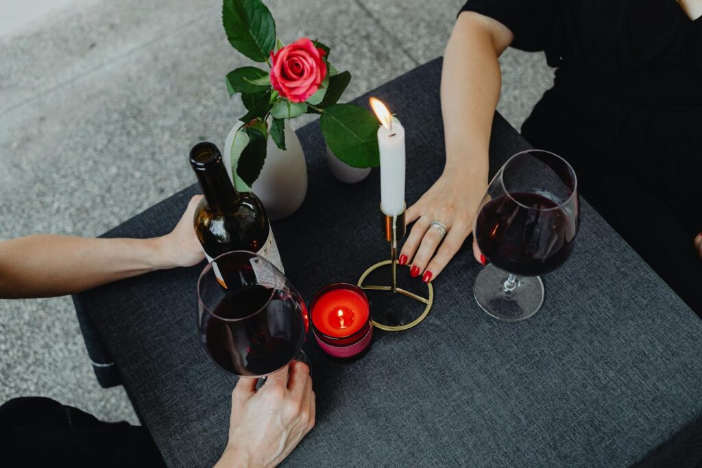 Intimate dining scene with wine, candles, and elegant decor.