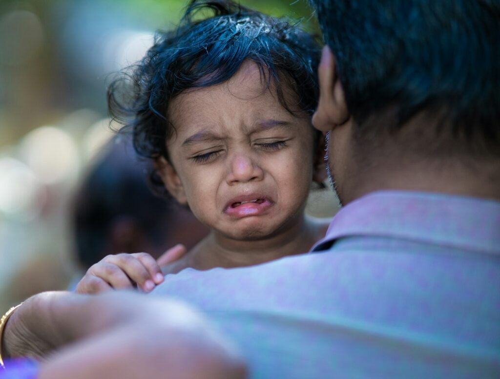 a woman holding a child with a surprised look on her face