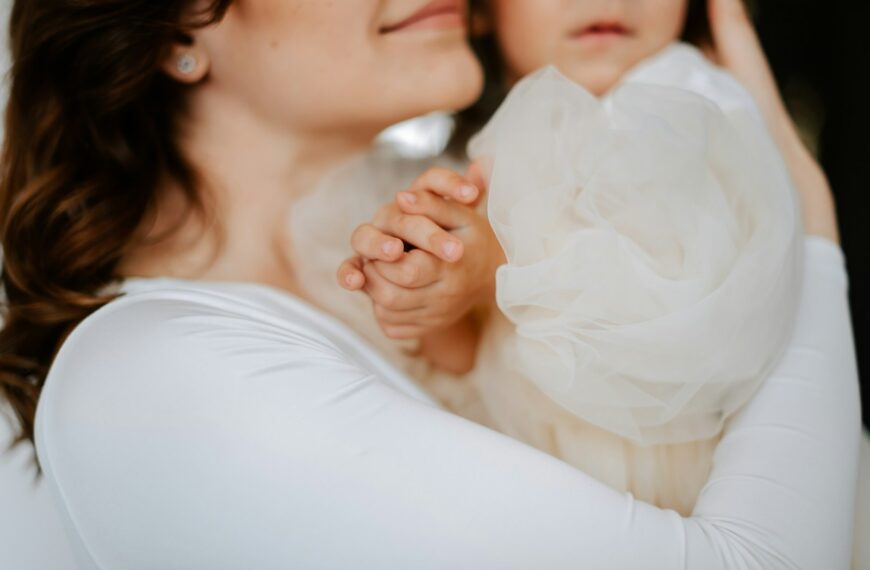 a woman holding a baby in her arms