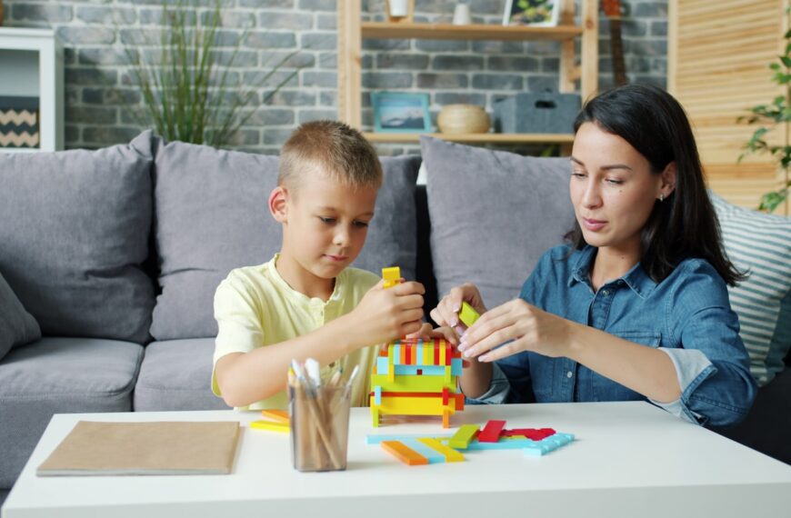 Mother and son building with colorful blocks