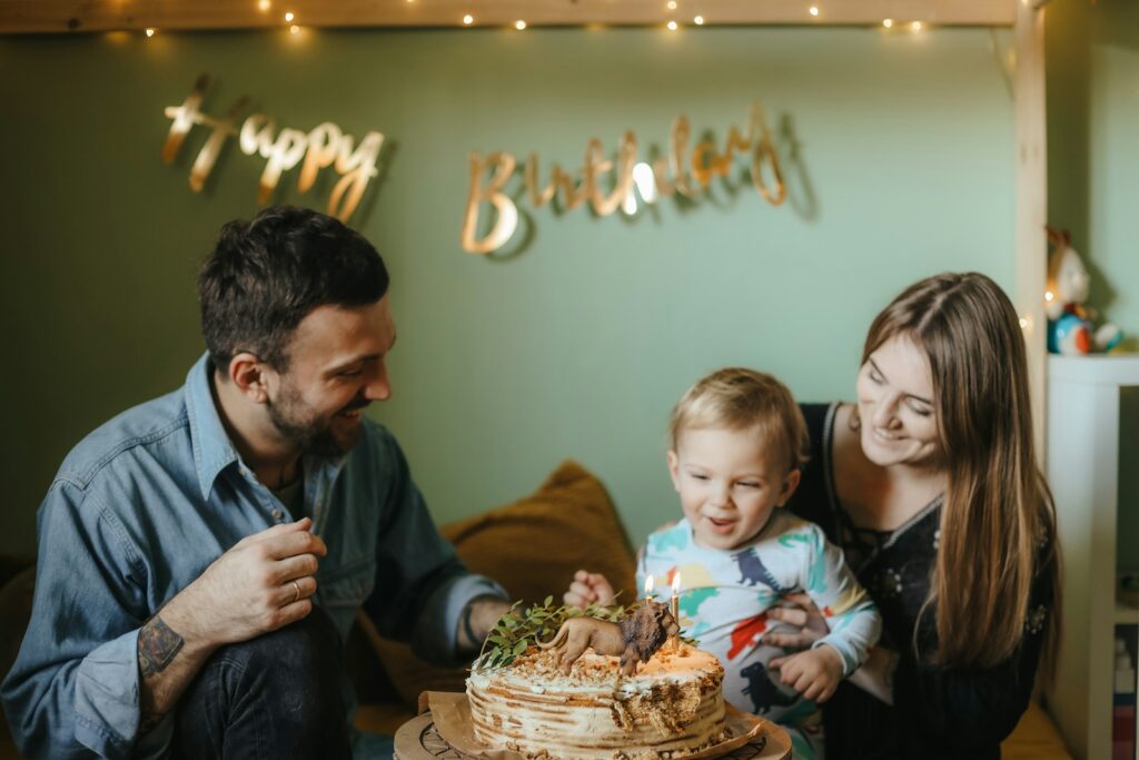 a man and woman with a child and a cake