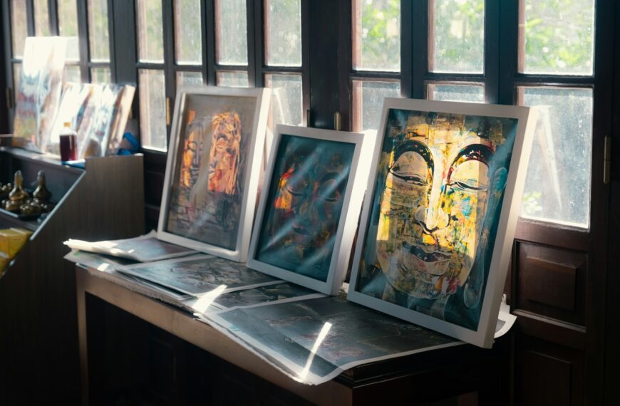 Art is displayed on a table near windows.