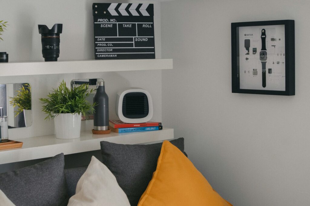 a living room with a gray couch and a white shelf