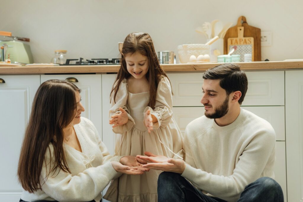 A group of people sitting around in a kitchen