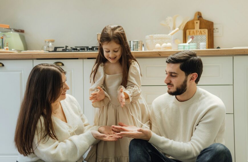 A group of people sitting around in a kitchen