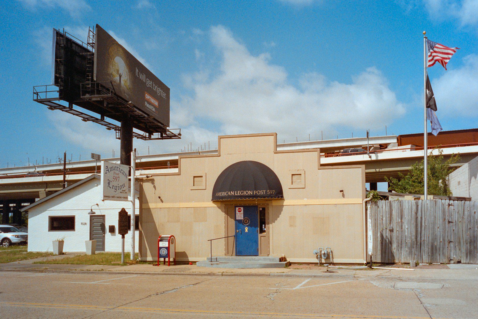 Building with arched entrance and large billboard
